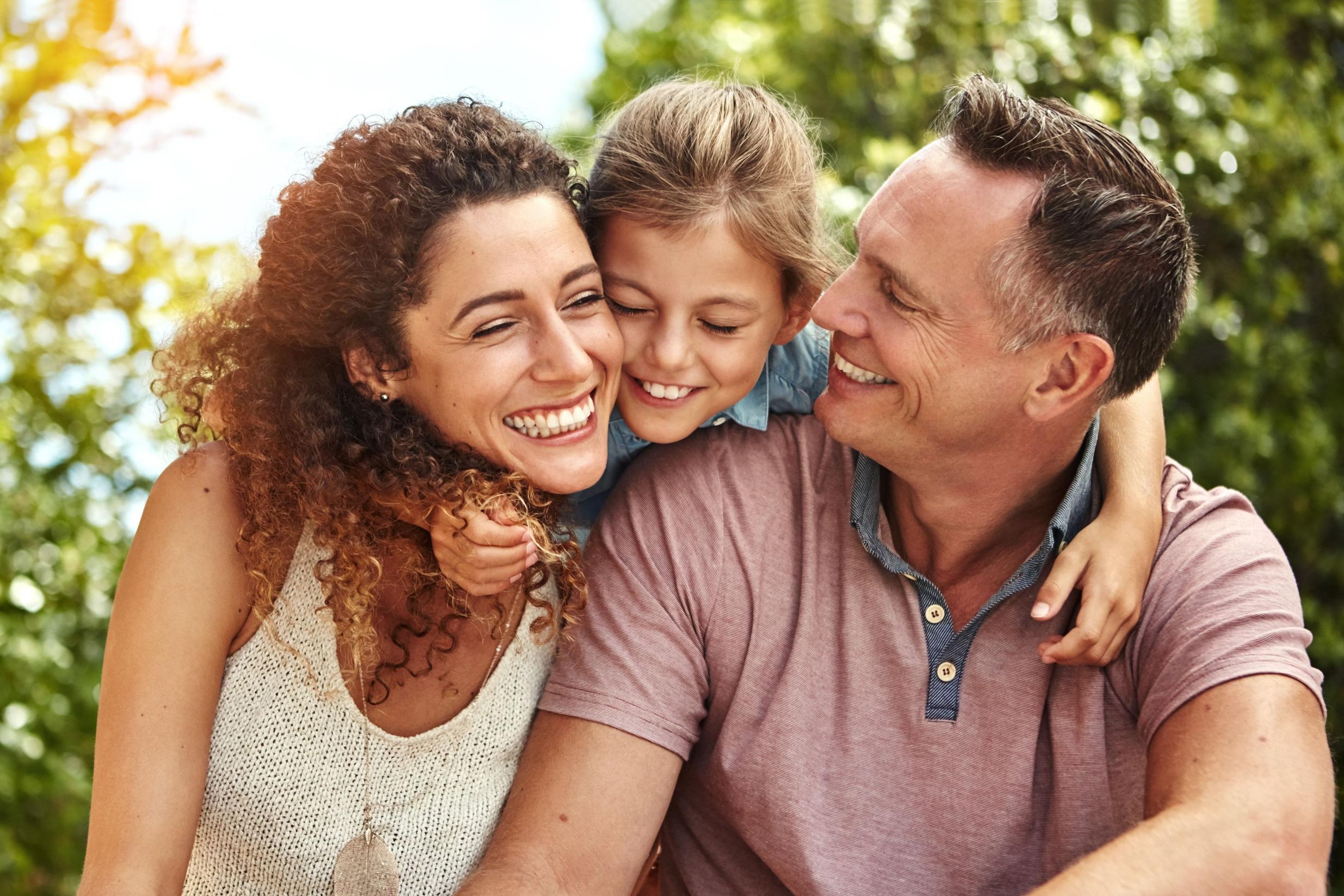 Smiling family embracing outdoors